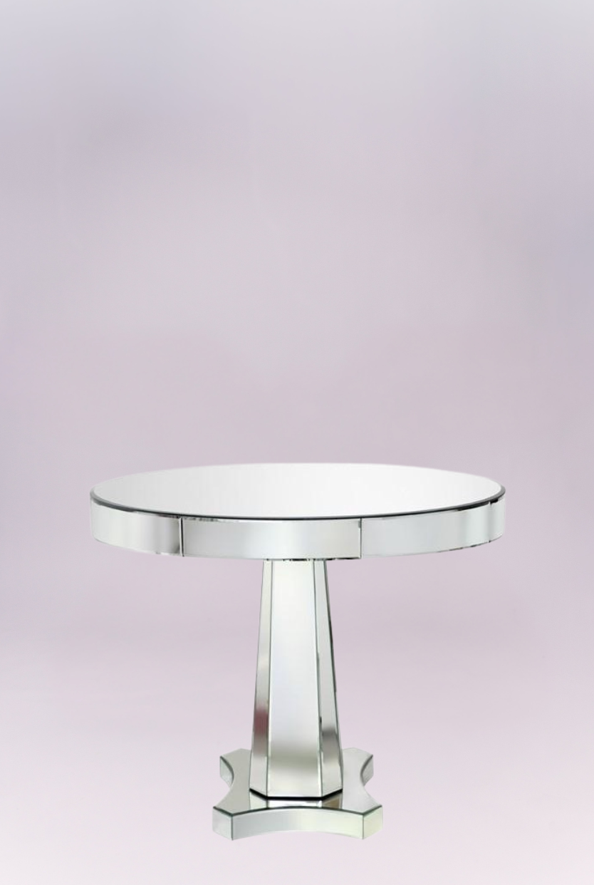 Mirrored table lends the mod interior glamorous impact. Atop an angular, geometric base, this furnishing's round top shines with beveled mirror surfaces.