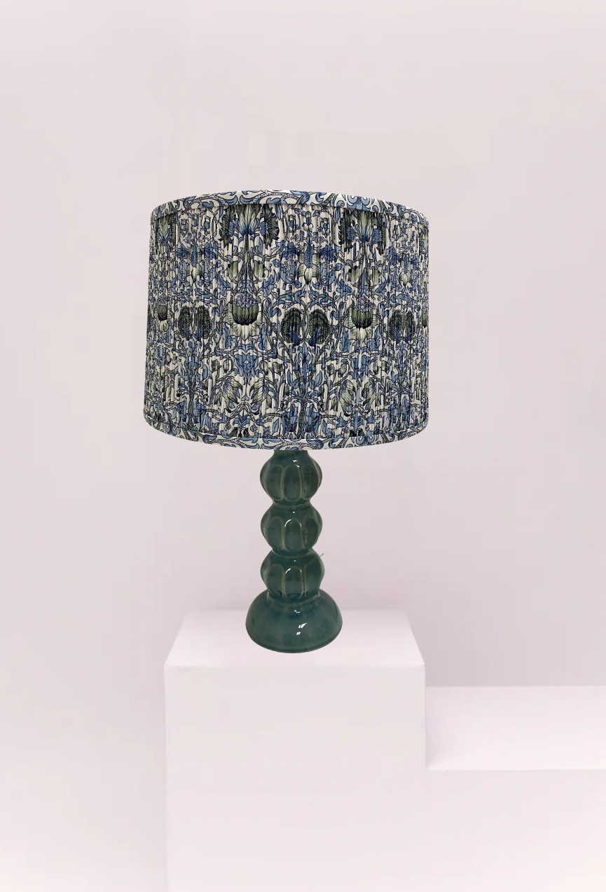 Lamp with a textured blue and black shade on a white background