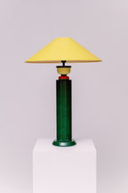 A  1980s French Postmodern high gloss lacquered wood table lamp with a speckled green and black primary color scheme and yellow and red accents.  Sophisticated and mesmerizing!