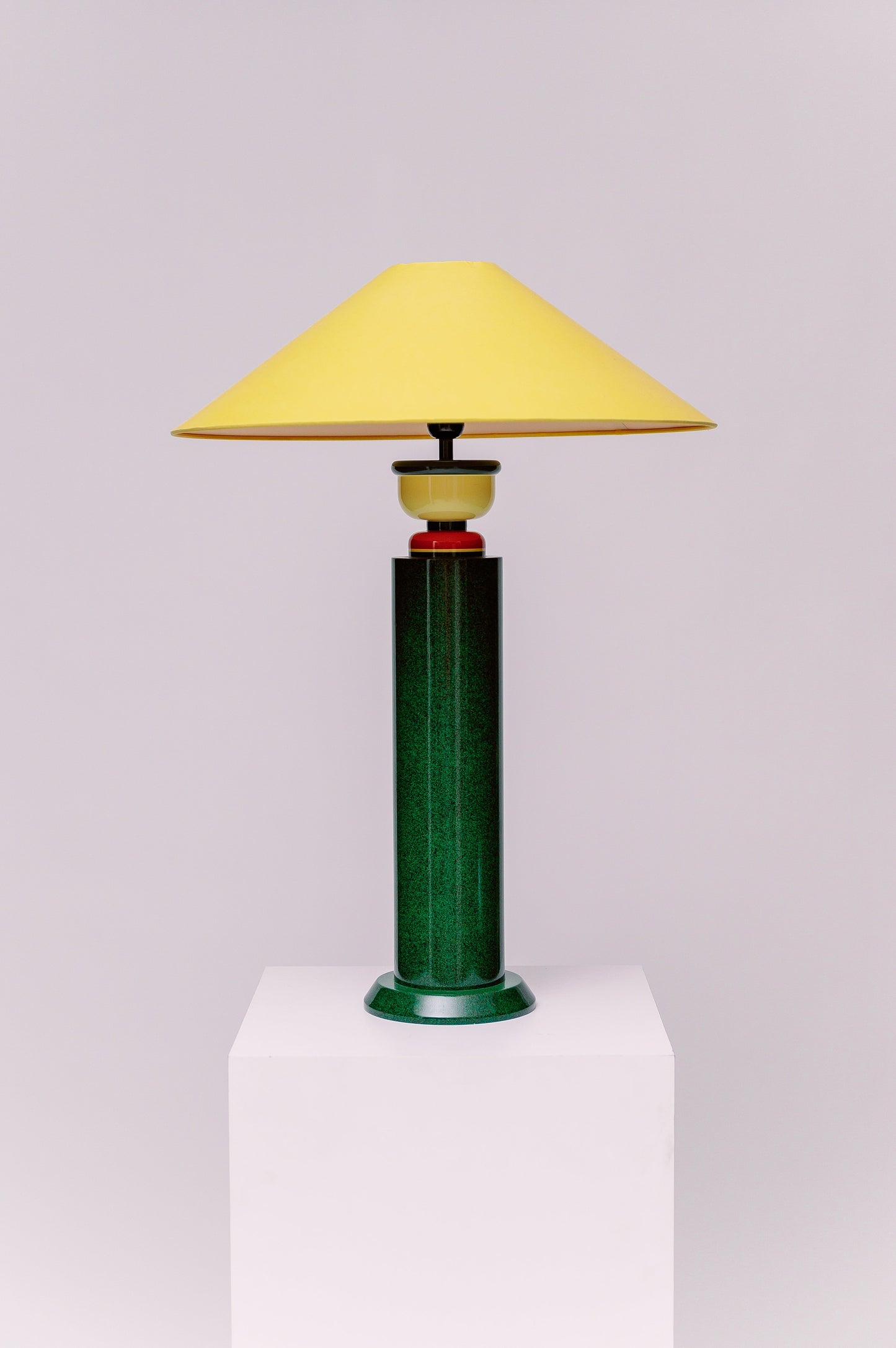 A  1980s French Postmodern high gloss lacquered wood table lamp with a speckled green and black primary color scheme and yellow and red accents.  Sophisticated and mesmerizing!