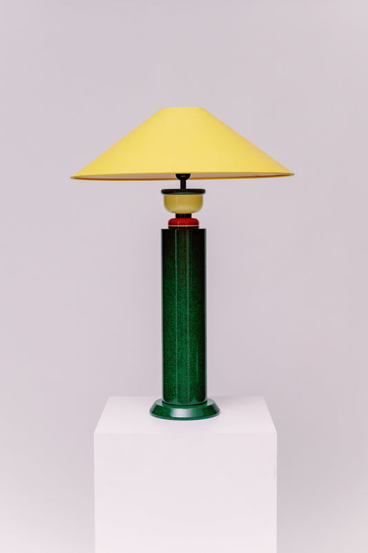 A  1980s French Postmodern high gloss lacquered wood table lamp with a speckled green and black primary color scheme and yellow and red accents.  Sophisticated and mesmerizing!