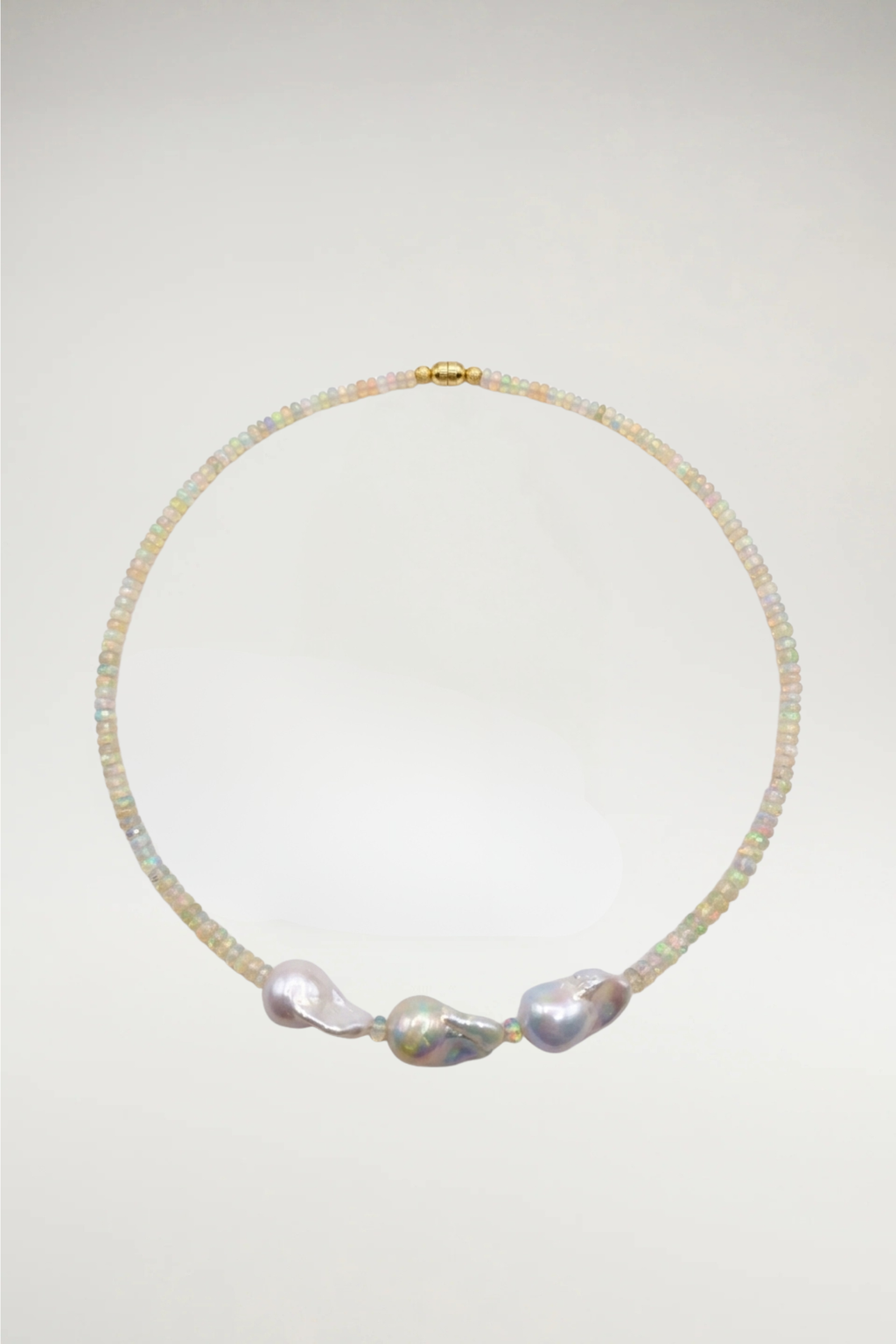 Luminous faceted opals meet the organic elegance of three baroque pearls. A shimmering, one-of-a-kind statement finished with a seamless gold magnetic clasp.