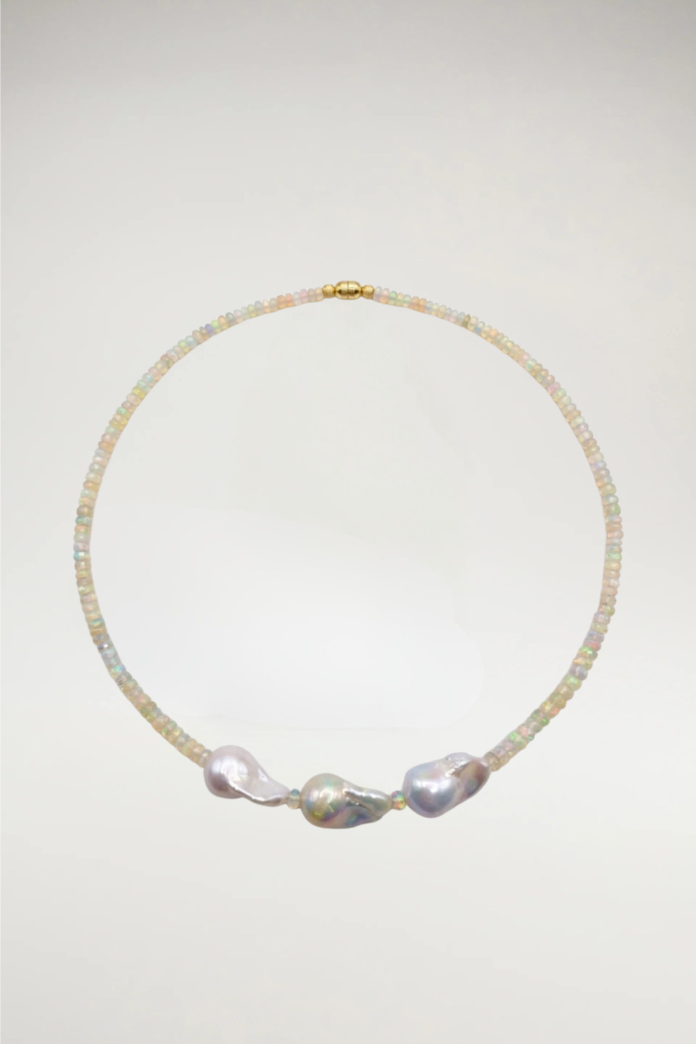 Luminous faceted opals meet the organic elegance of three baroque pearls. A shimmering, one-of-a-kind statement finished with a seamless gold magnetic clasp.
