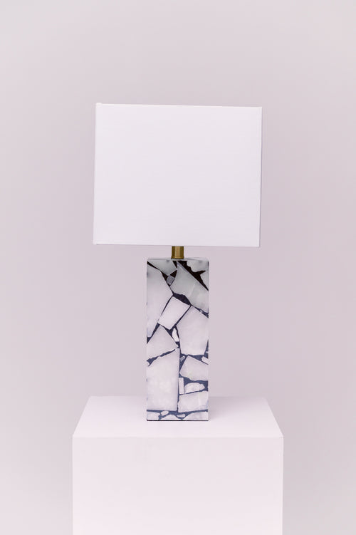 Standing at 25 inches tall, this stunning lamp features a robust stone body complemented by an iron finial, creating an exquisite statement piece for any room.