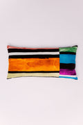 This striking pillow features a vibrant, abstract composition of horizontal stripes and color blocks. The main body showcases bold lines of electric orange, black, and crisp white, while the end panel explodes with brilliant jewel tones of teal, magenta, and emerald green. This lumbar pillow is a confident statement piece, perfect for anchoring a minimalist sofa or injecting maximalist energy into any room.