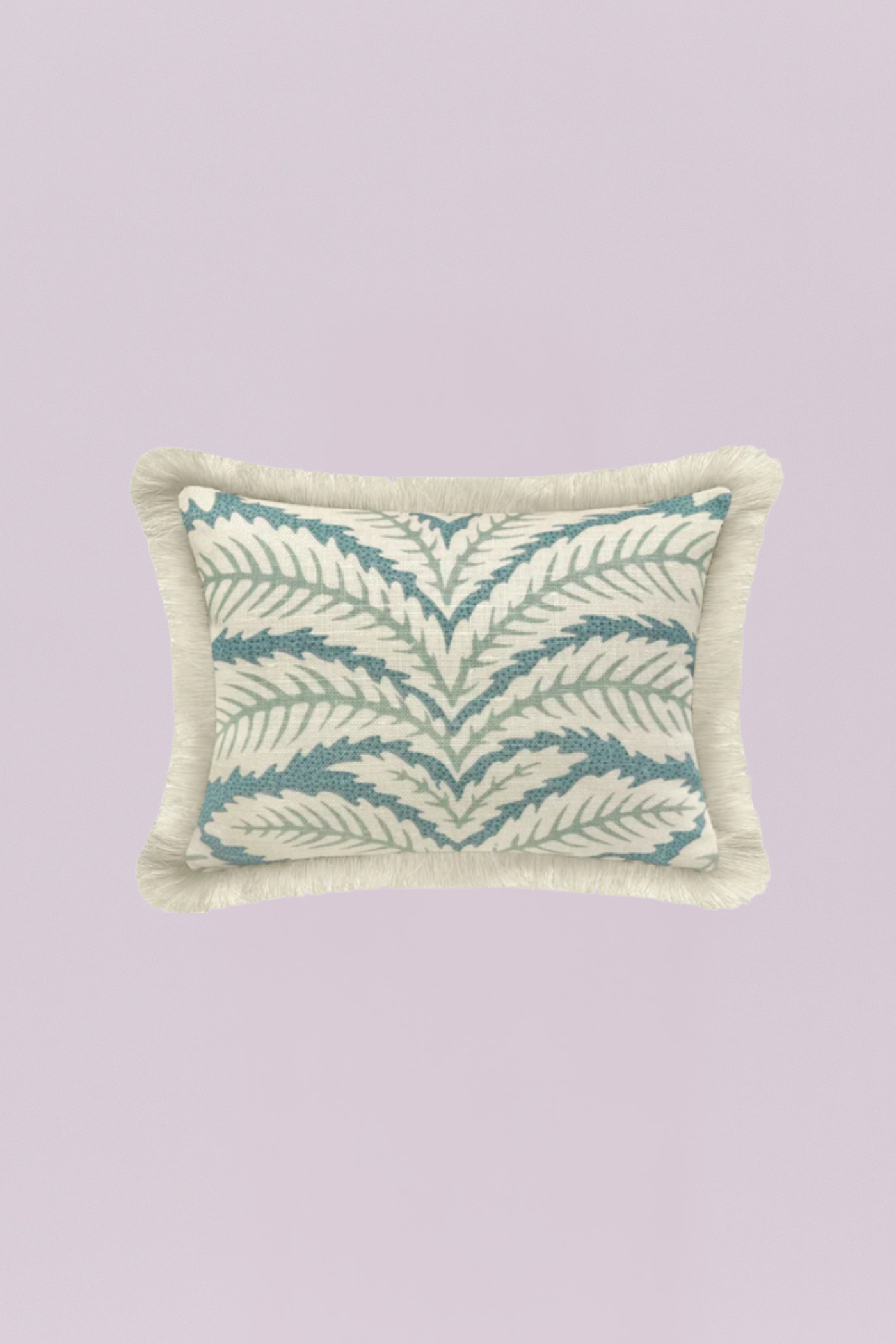 A charming rectangular pillow featuring a classic, repeating tropical leaf or frond pattern in soothing aqua and sage tones on a light neutral background. The piece is beautifully finished with a dense, natural ivory fringe, adding coastal texture and a relaxed, breezy feel.