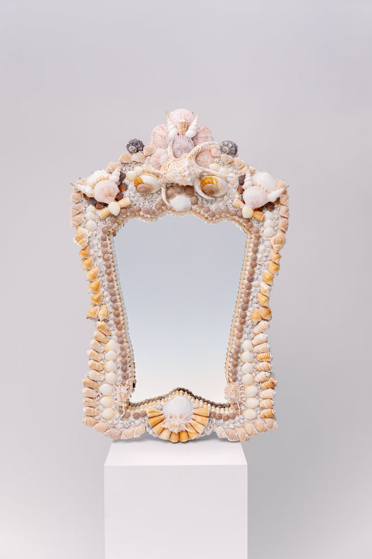 This pair of mirrors has  a majestic, regal shape, adorned with a rich arrangement of shells. A perfect addition to your coastal retreat!