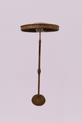 Vintage from the Florida, Everglades. This striking floor lamp features a complete woven rattan construction, embodying a warm, organic aesthetic typical of mid-century coastal and tropical designs. The piece is defined by its unique "parasol" or mushroom-style shade, which provides a wide, downward-dispersed light perfect for creating ambient atmosphere in a living space or sunroom.