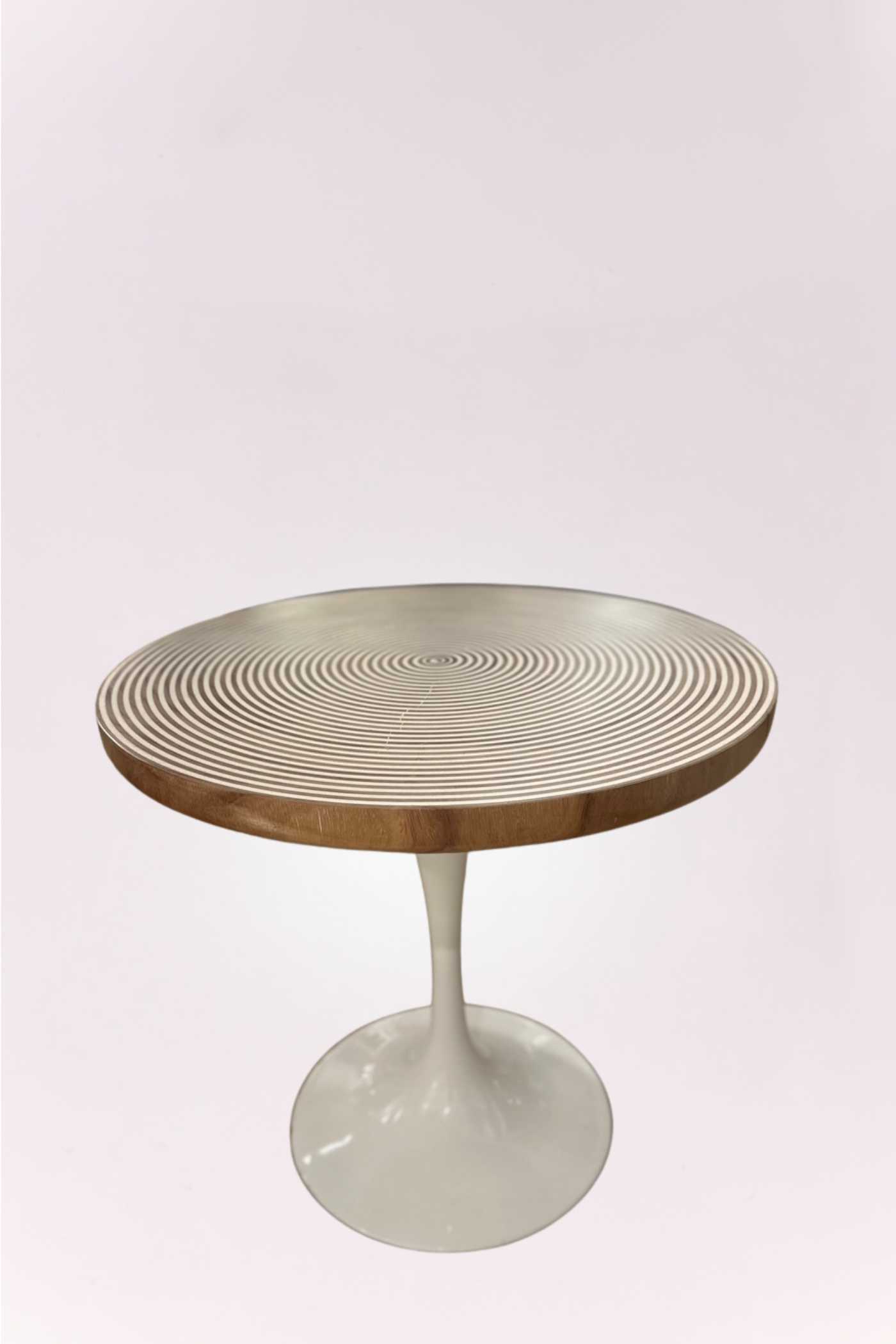 Round bistro table featuring a solid wood top with concentric design and a sleek white pedestal base