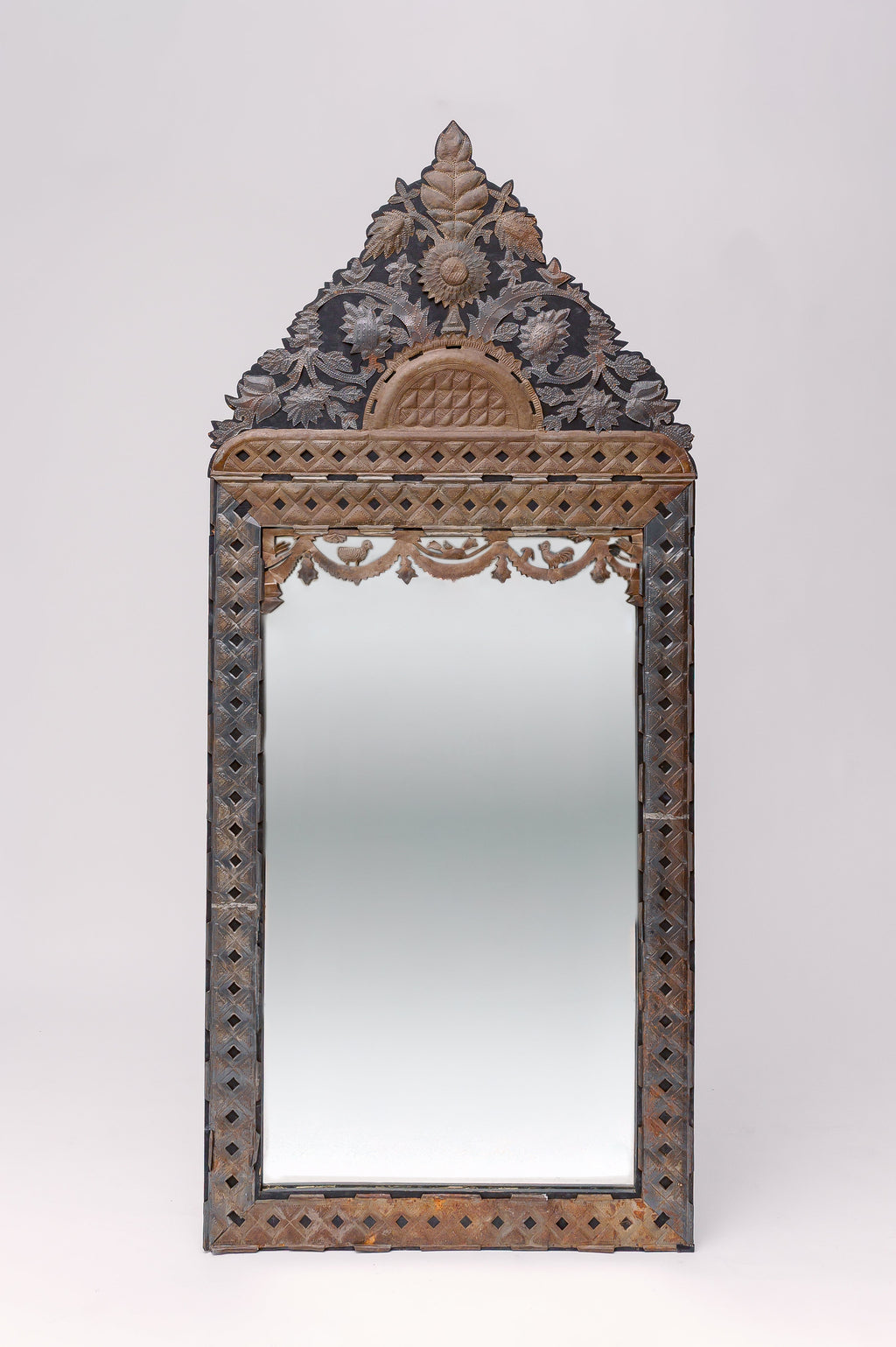 Translating to "the ancient vine", this large tin adorned mirror features intricate carvings of florals, animals and geometric shapes.