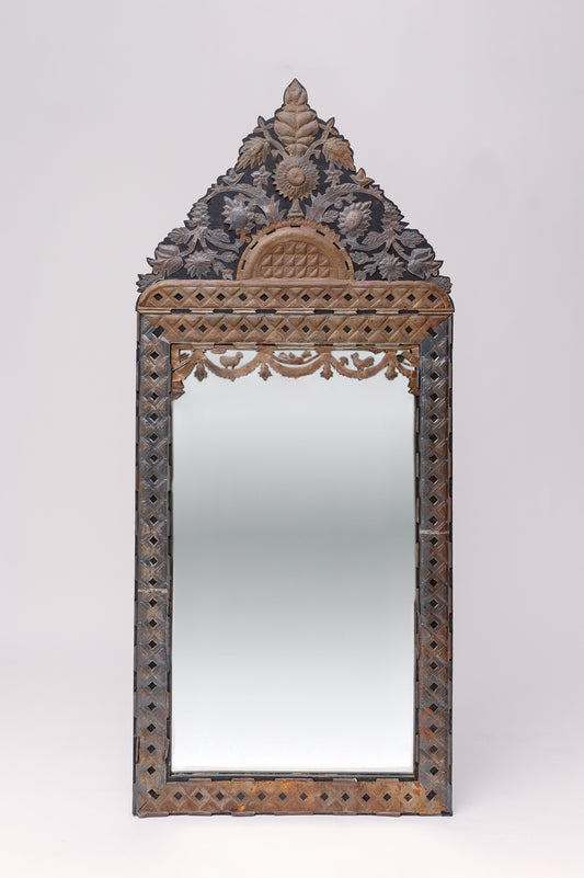 Translating to "the ancient vine", this large tin adorned mirror features intricate carvings of florals, animals and geometric shapes.