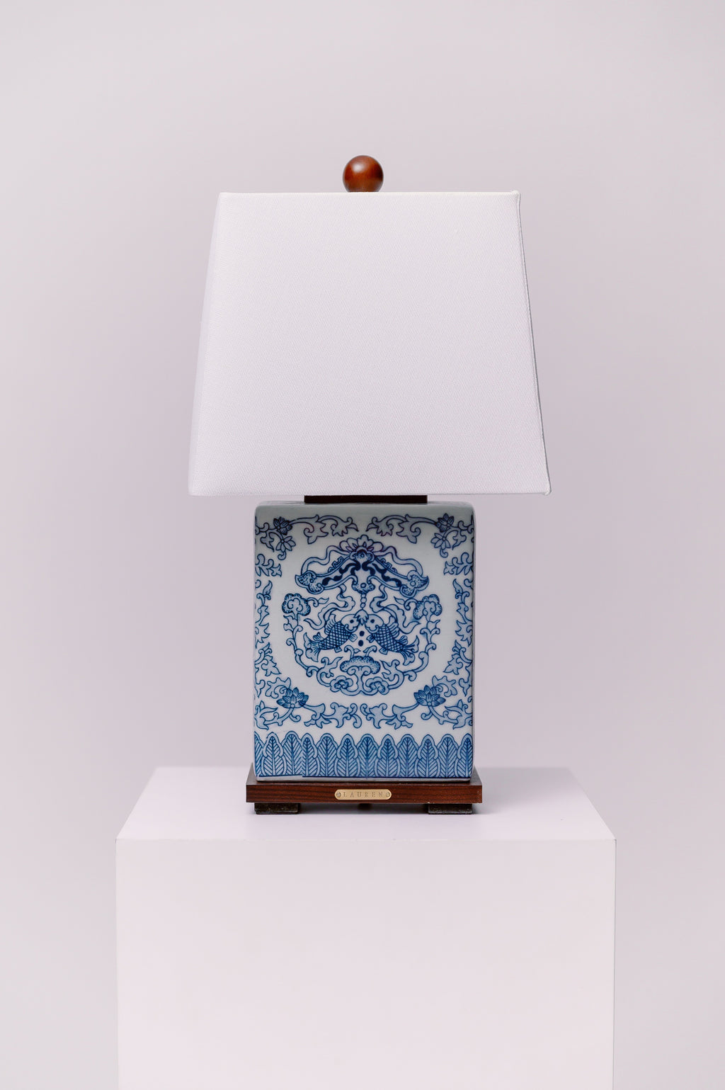 Ralph Lauren blue and white ceramic table lamp mounted on a walnut base with koi fish on both sides.