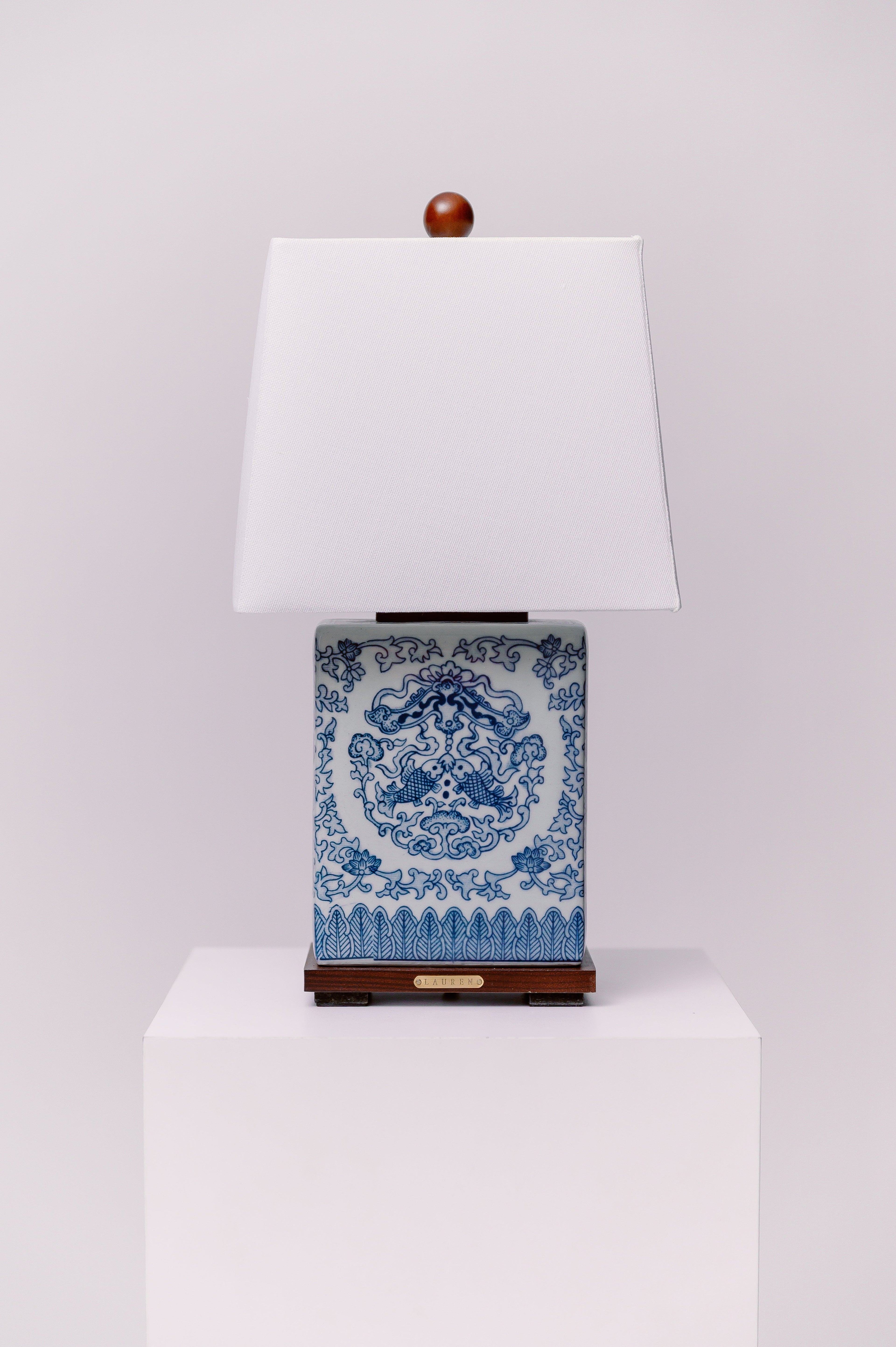 Ralph Lauren blue and white ceramic table lamp mounted on a walnut base with koi fish on both sides.