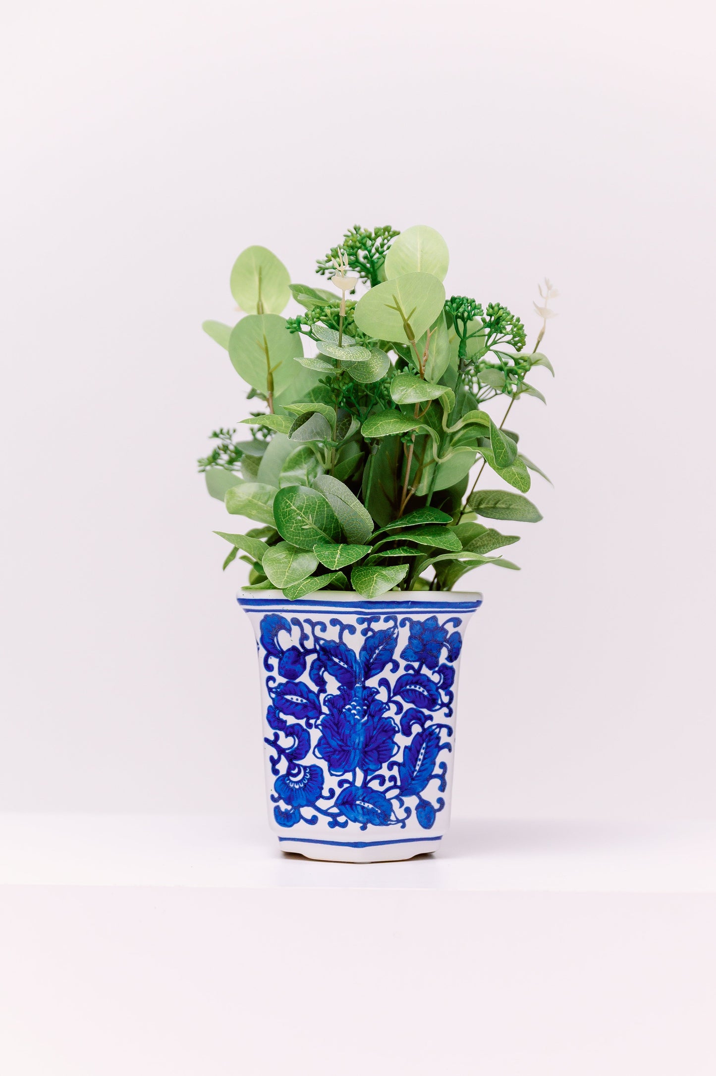 This refined porcelain planter features a tapered tall form with a flared rim, hand-painted in vivid cobalt blue underglaze. With its graceful proportions and rich cobalt tones, this piece adds timeless chinoiserie charm to both traditional and contemporary interiors.