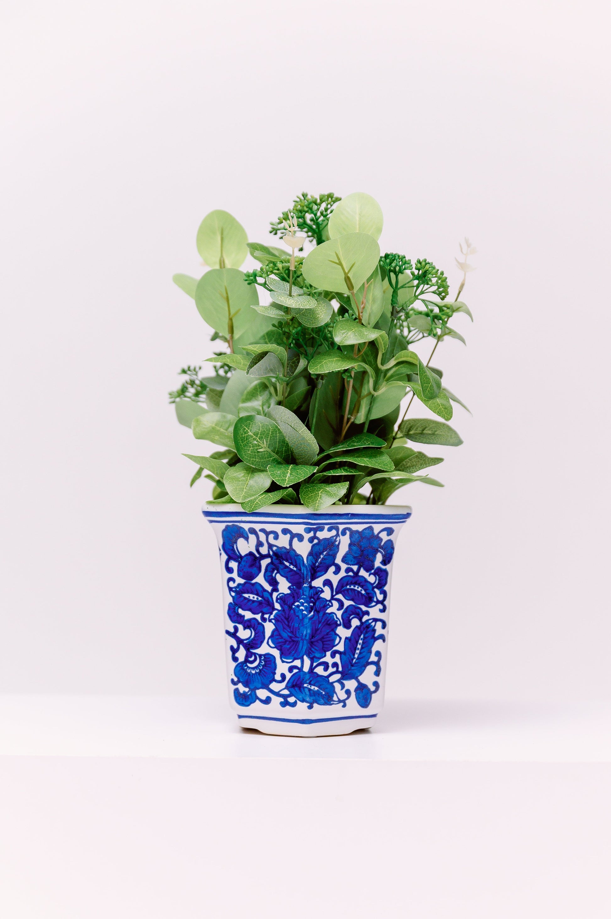 This refined porcelain planter features a tapered tall form with a flared rim, hand-painted in vivid cobalt blue underglaze. With its graceful proportions and rich cobalt tones, this piece adds timeless chinoiserie charm to both traditional and contemporary interiors.
