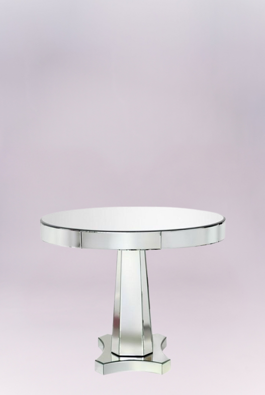 Mirrored table lends the mod interior glamorous impact. Atop an angular, geometric base, this furnishing's round top shines with beveled mirror surfaces.