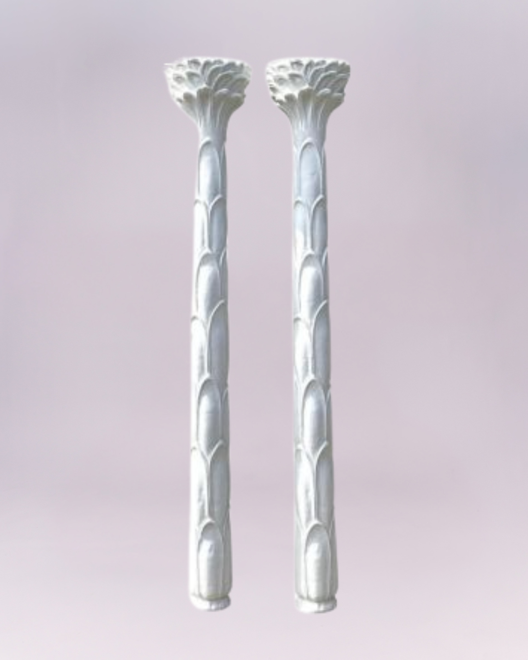 Pair of Serge Roche–style palmette torchiere lamps. These wall-mounted, palm-tree–inspired floor lamps are cast in fiberglass with a warm, layered patina that mimics painted plaster. Their streamlined, sculptural palm-leaf design gives them a modern yet timeless look. Each stands 82" tall and measures 13" wide by 6.5" deep.