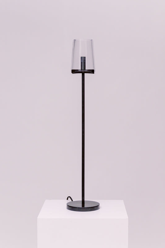 Created by renowned lighting designer Jonathan Browning, this table lamp distills the hurricane lamp to its essence. Inspired by French fixtures of the 1940s, its hand-blown shades are a traditional tapered shape, while the solid brass frame offers a modern counterpoint.