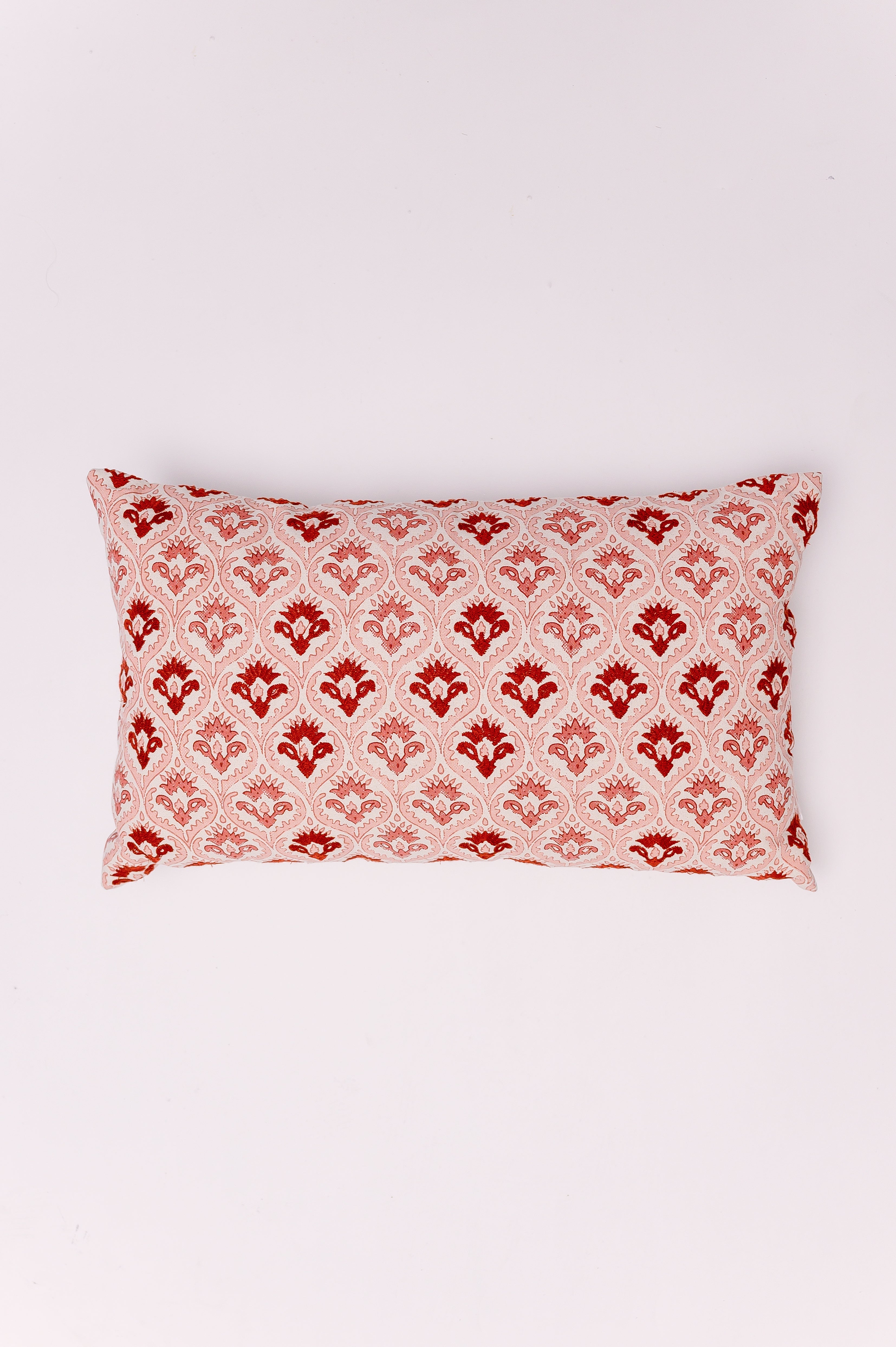 Infuse your space with warmth and timeless pattern using The Raspberry Damask Lumbar. This eye-catching pillow features a dense, repeating damask motif that instantly adds a touch of classic elegance. Its elongated lumbar shape is perfect for providing comfortable support while serving as a bold, sophisticated focal point on an armchair, bench, or as a striking accent on a neutral bedspread.