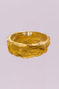 Bring a grounded, organic feel to your space with this raw edge golden onyx marble bowl. Carved from solid stone, this piece highlights the natural beauty of layered mineral formations, with rich golden tones, soft cream veining, and subtle variations that make it entirely one of a kind.