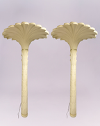 Channel the iconic glamour of French designer Serge Roche with this breathtaking pair of vintage palm tree torchere floor lamps. Each lamp is a dramatic sculptural statement, expertly crafted from molded resin with a creamy, plaster-like finish that captures the Neoclassical elegance of the Art Deco era. $3,500.00each