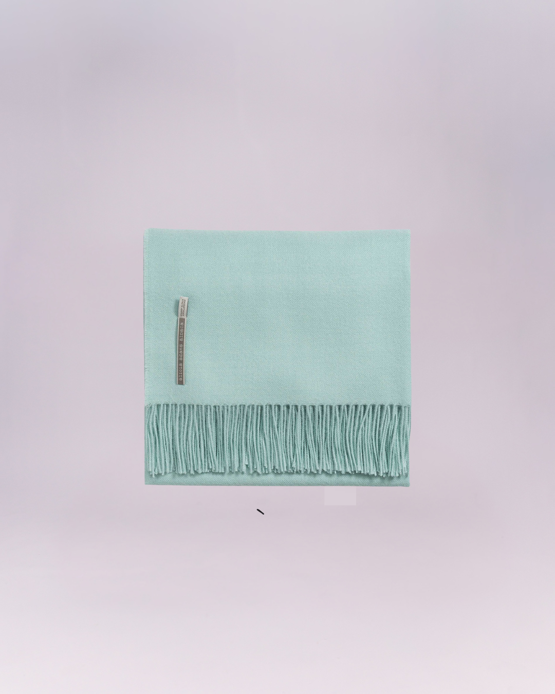 Hand-loomed from pure baby alpaca, it is soft, luminous, and effortlessly refined.