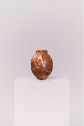 Crafted from genuine stone, this vase showcases the raw beauty of earth-toned marble. The heavy, high-quality feel provides a perfect contrast to its smooth, elegant shape.