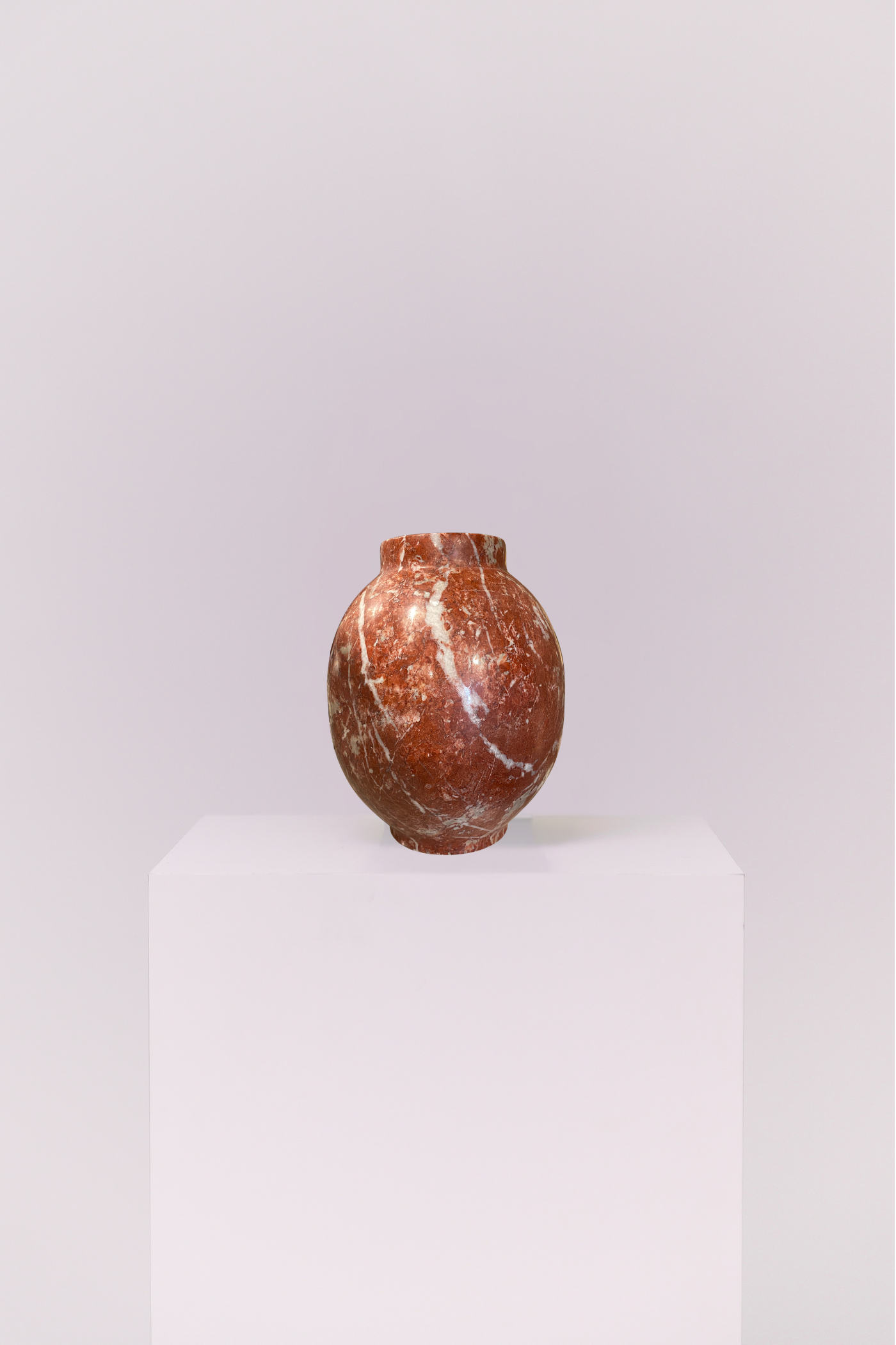 Crafted from genuine stone, this vase showcases the raw beauty of earth-toned marble. The heavy, high-quality feel provides a perfect contrast to its smooth, elegant shape.