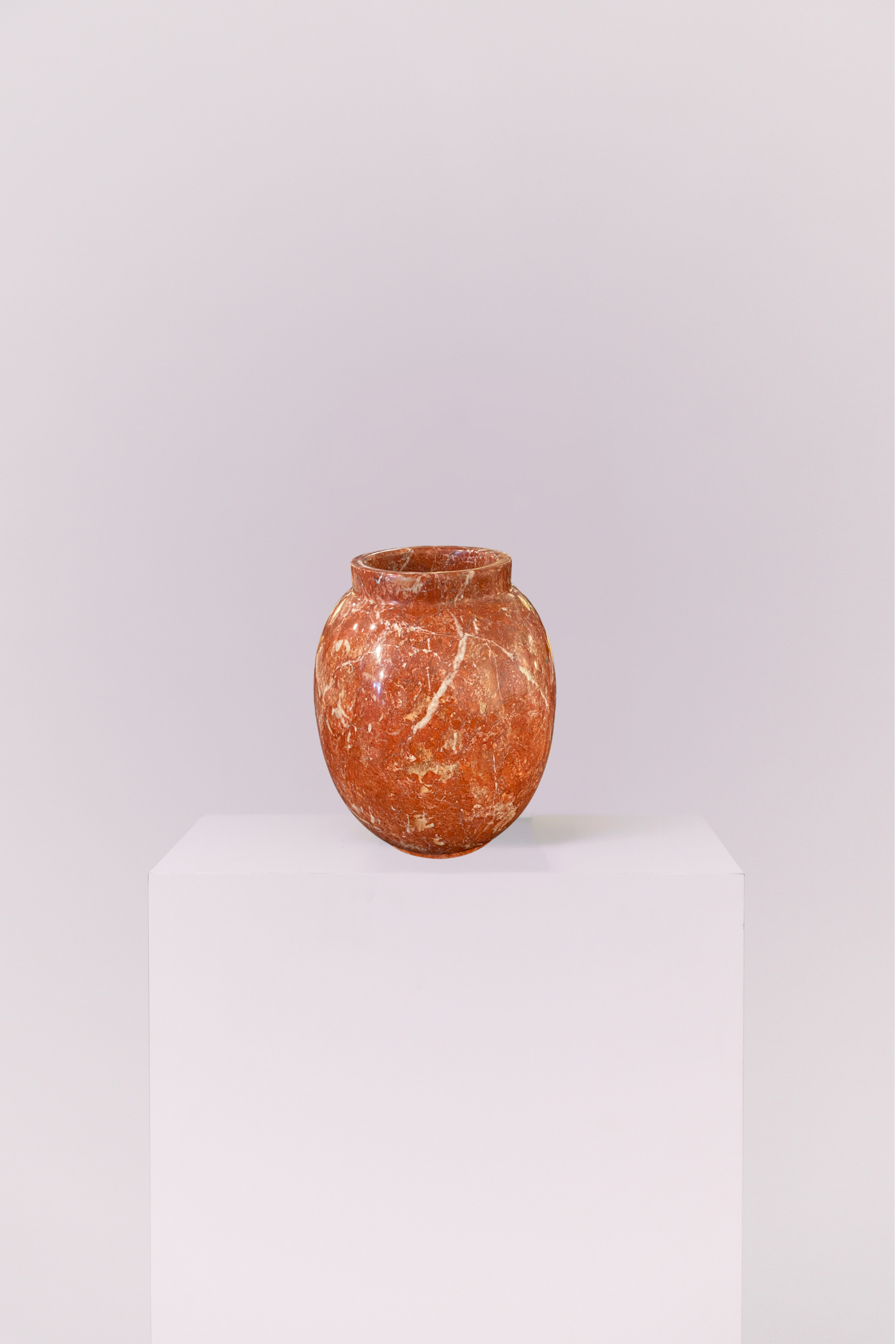 Crafted from genuine stone, this vase showcases the raw beauty of earth-toned marble. The heavy, high-quality feel provides a perfect contrast to its smooth, elegant shape.