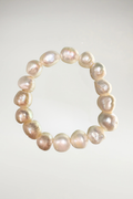 Indulge in the striking warmth and modern elegance of this breathtaking creamy white pearl statement bracelet. Composed of exceptional, large-scale cultured pearls, this piece commands attention with its substantial presence and an extraordinarily rare, high-shine metallic finish.