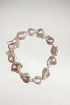 Make a statement with this stunning bracelet crafted from oversized, organic irridescent creamy white baroque pearls. Featuring a brilliant, luminous nacre and beautiful natural contours, it's a timeless yet modern accent piece for any wardrobe.
