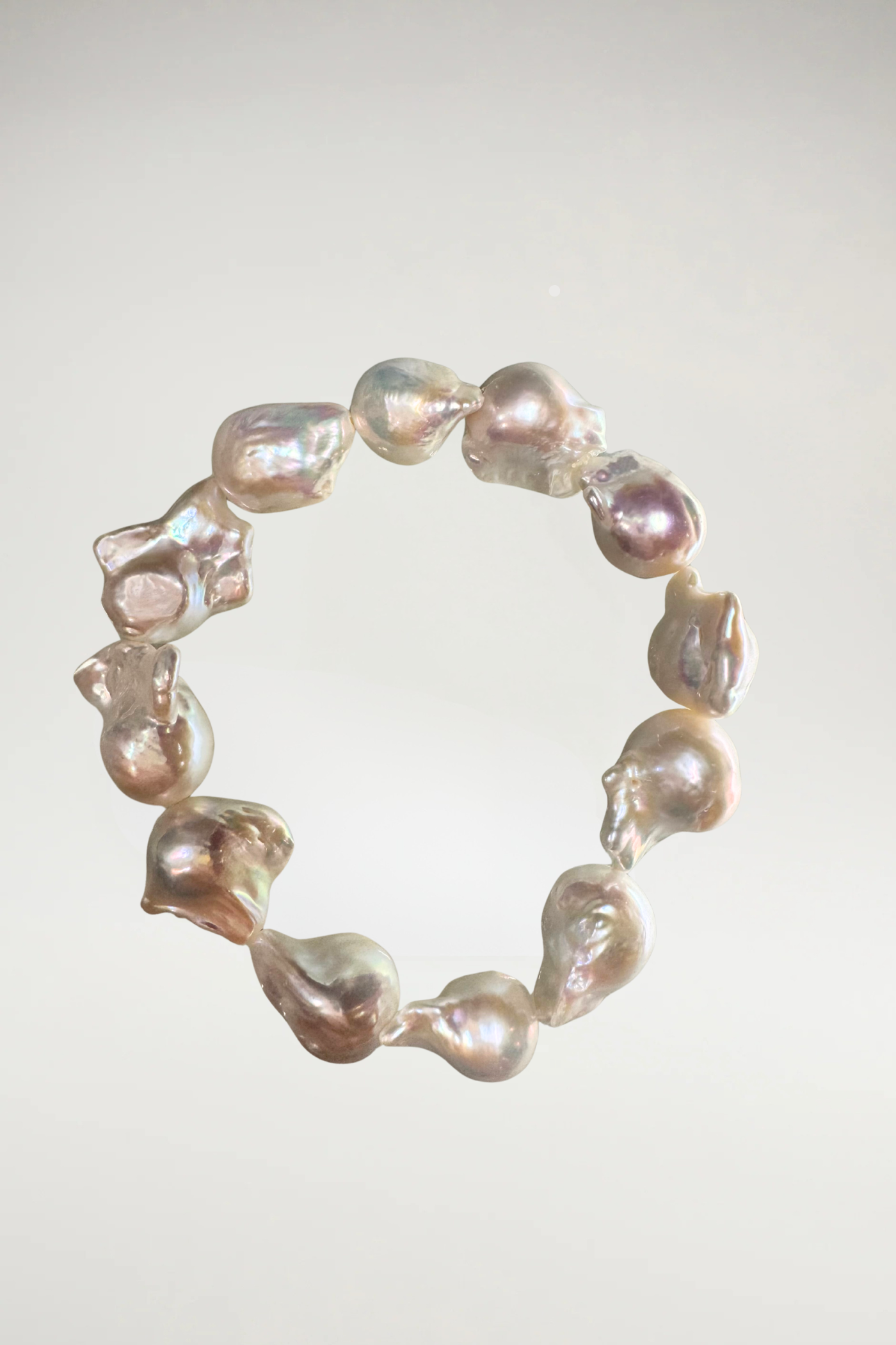 Make a statement with this stunning bracelet crafted from oversized, organic irridescent creamy white baroque pearls. Featuring a brilliant, luminous nacre and beautiful natural contours, it's a timeless yet modern accent piece for any wardrobe.