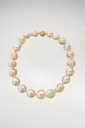 The ultimate expression of purity and light, The Bianca features exceptionally stark white baroque pearls. Unlike the warm champagne or soft ivory of our other strands, this piece is defined by a bright, snowy luster and a crisp, high-contrast finish. Secured with a polished gold magnetic orb clasp, it offers a clean and striking silhouette.