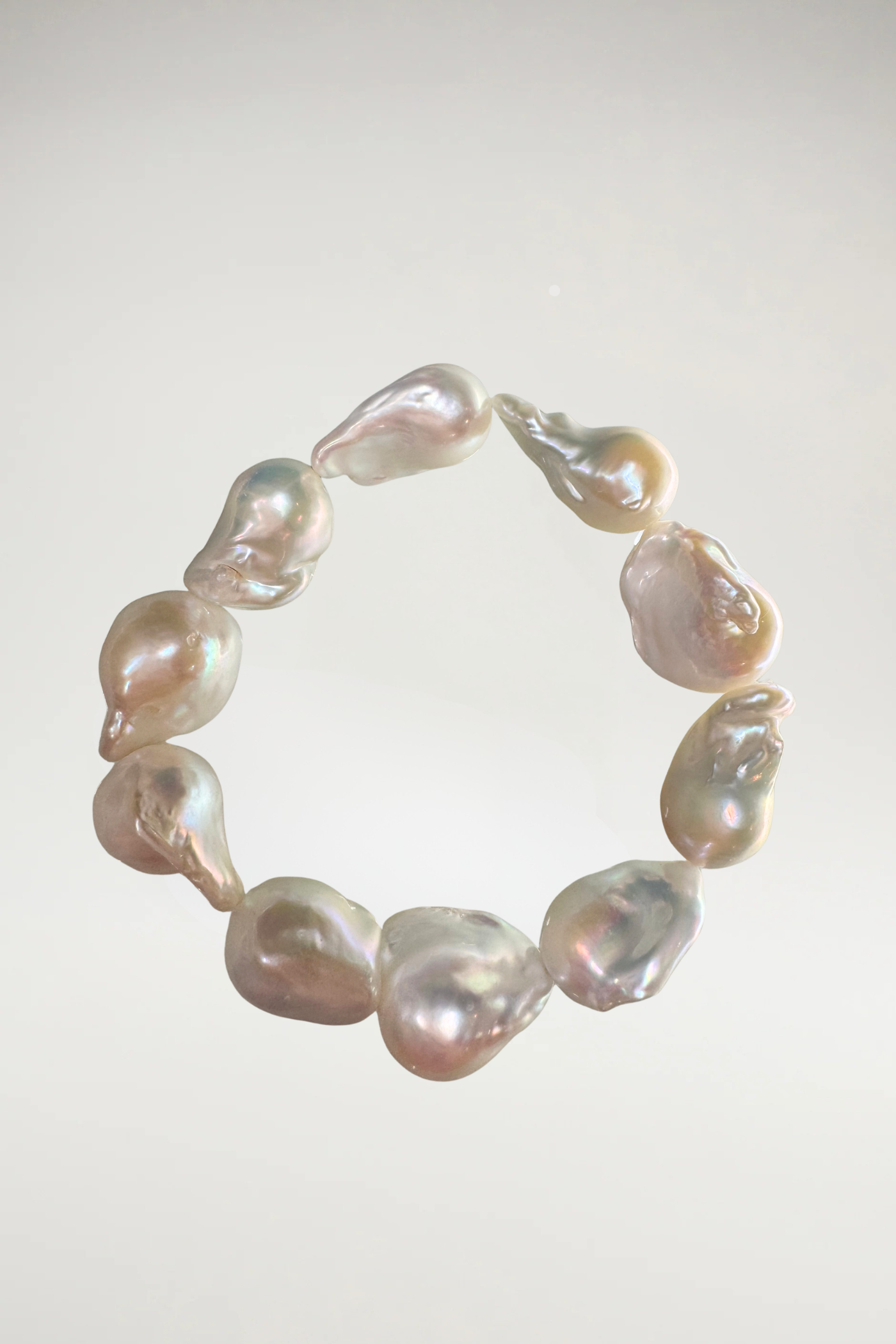Make a statement with this stunning bracelet crafted from oversized, organic irridescent creamy white baroque pearls. Featuring a brilliant, luminous nacre and beautiful natural contours, it's a timeless yet modern accent piece for any wardrobe.