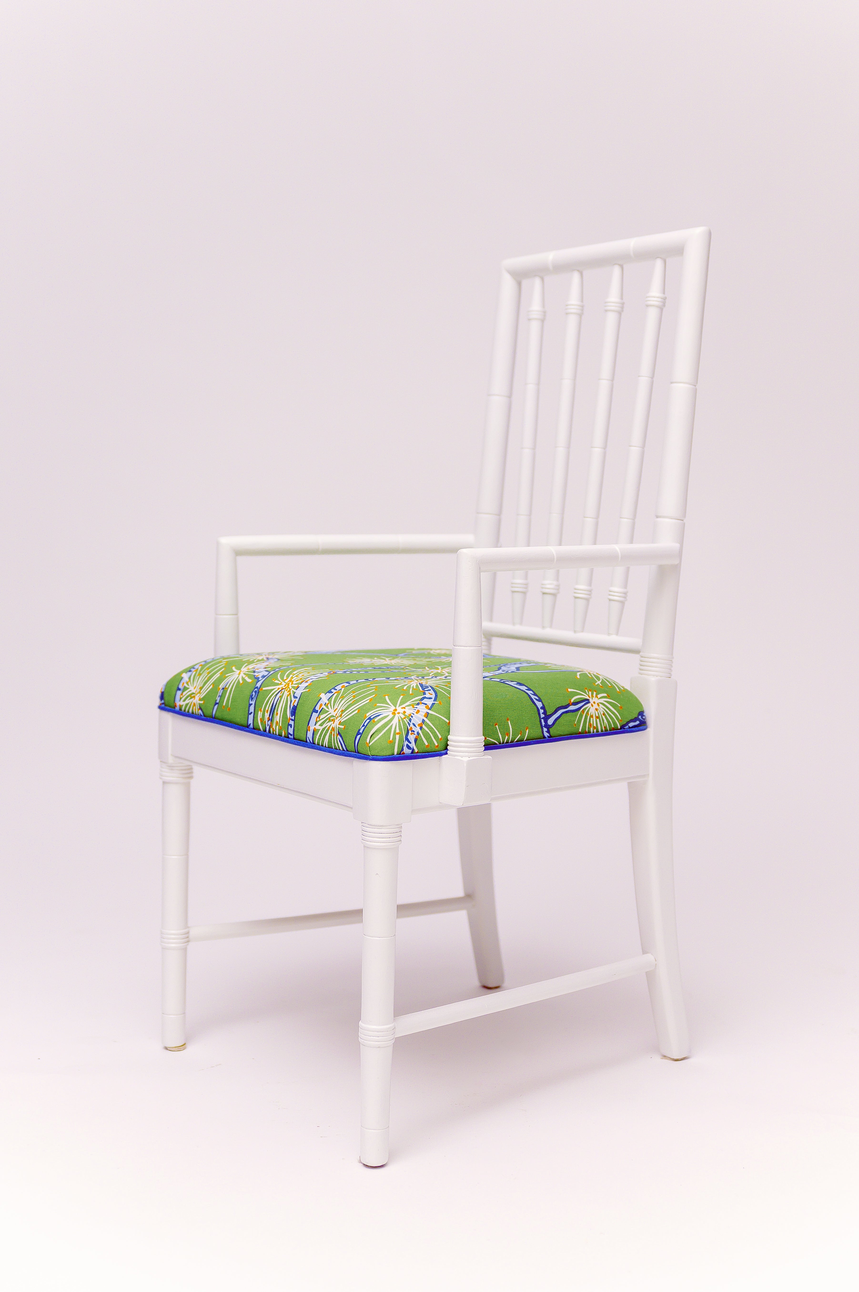 Classic faux-bamboo styling meets a splash of poolside personality. With its crisp refurbished antique in high gloss white frame. Upholstery fabric is by Ferrick Mason in Calliandra, this armchair is ready to bring a sunny, tropical breeze straight into your favorite corner. Set includes 6 armless chairs and two arm head chairs.