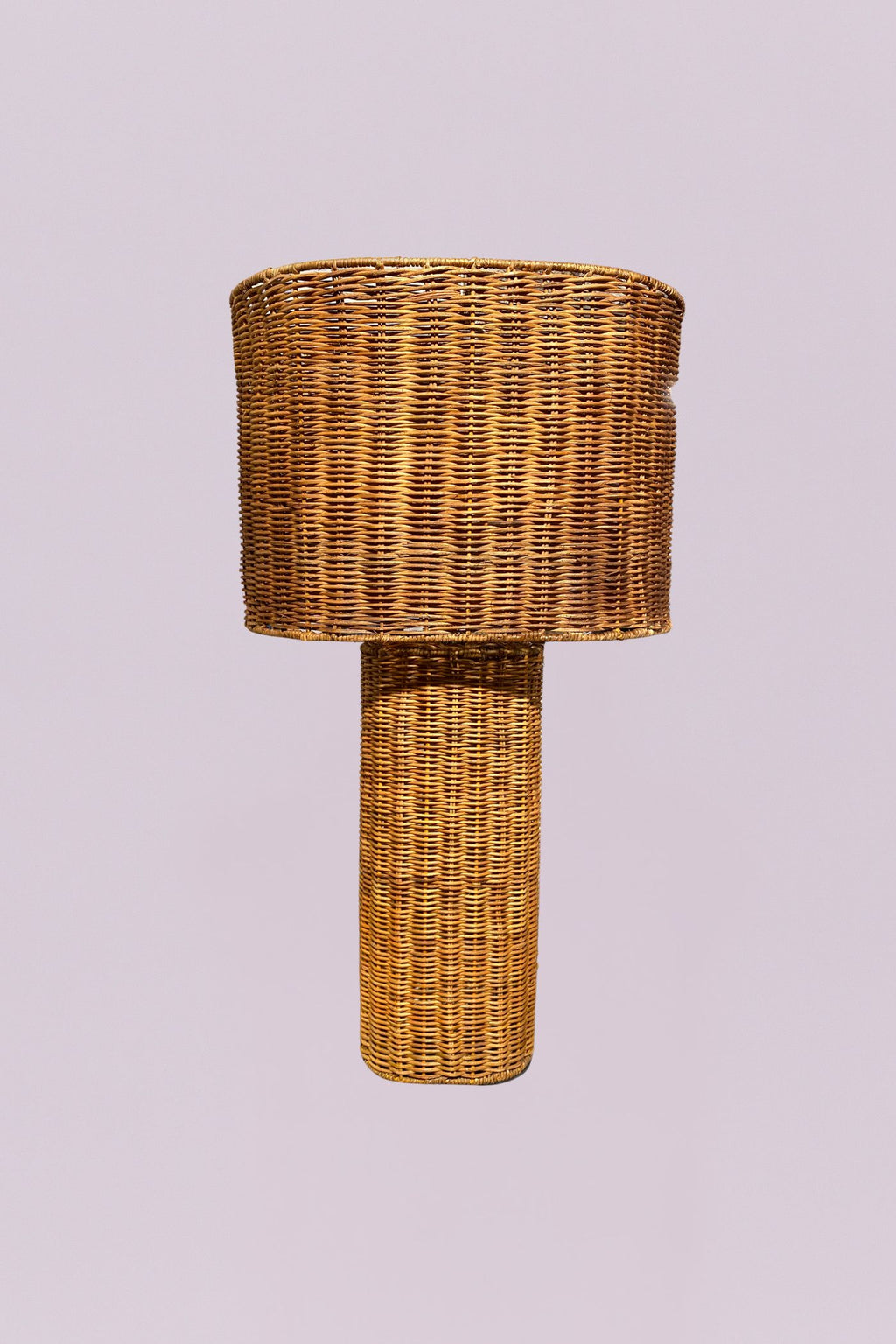 This hand-woven rattan statement piece features a delightfully chunky cylindrical base and an oversized drum shade for a look that's equal parts rustic and eccentric. It casts a warm, textured glow perfect for illuminating your unique style and sparking "where did you find that?" conversations.
