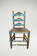 Antique wood chairs featuring beautifully aged carved details and a handwoven rush seat. The natural fiber seat adds texture, durability, and classic charm while providing comfortable support.