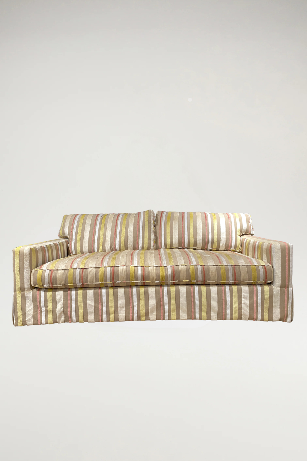 Add a vibrant, sophisticated touch to your space with this designer piece featuring a shimmering stripe pattern in coral, off-white, yellow, and natural linen. The tailored silhouette includes a single-bench seat and a classic dressmaker skirt, offering an elegant yet inviting aesthetic.