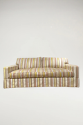 Add a vibrant, sophisticated touch to your space with this designer piece featuring a shimmering stripe pattern in coral, off-white, yellow, and natural linen. The tailored silhouette includes a single-bench seat and a classic dressmaker skirt, offering an elegant yet inviting aesthetic.