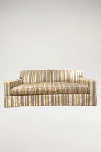 Add a vibrant, sophisticated touch to your space with this designer piece featuring a shimmering stripe pattern in coral, off-white, yellow, and natural linen. The tailored silhouette includes a single-bench seat and a classic dressmaker skirt, offering an elegant yet inviting aesthetic.