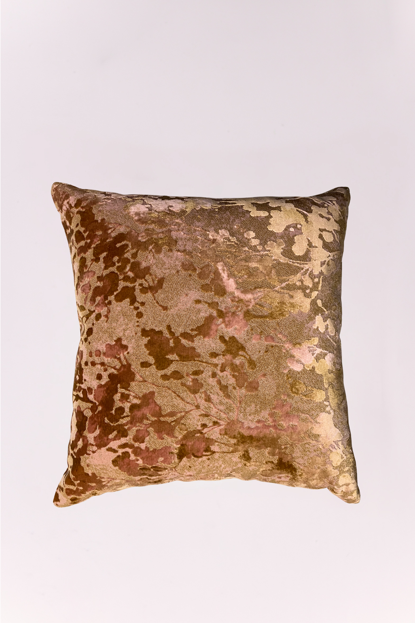 Add a layer of artistic texture to your seating with this 24x24 designer throw pillow. Featuring a luxurious cut-velvet finish, the fabric showcases a distressed, abstract botanical pattern that mimics the look of dappled sunlight through autumn leaves