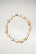 A bold, sculptural statement of oversized baroque pearls. Each stone features a unique, organic silhouette with a rich, high-luster finish. Completed with a polished silver magnetic orb clasp for a modern, sophisticated touch.