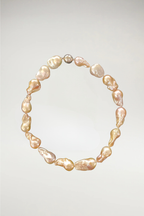 A bold, sculptural statement of oversized baroque pearls. Each stone features a unique, organic silhouette with a rich, high-luster finish. Completed with a polished silver magnetic orb clasp for a modern, sophisticated touch.