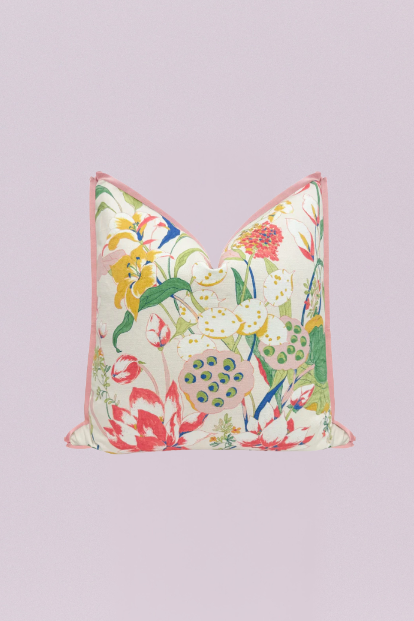 A vibrant botanical pillow featuring a waterlily and floral print in shades of red, yellow, green, and pink on a cream background, finished with a delicate pink piped edge.