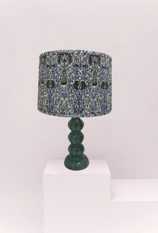 Lamp with a textured blue and black shade on a white background