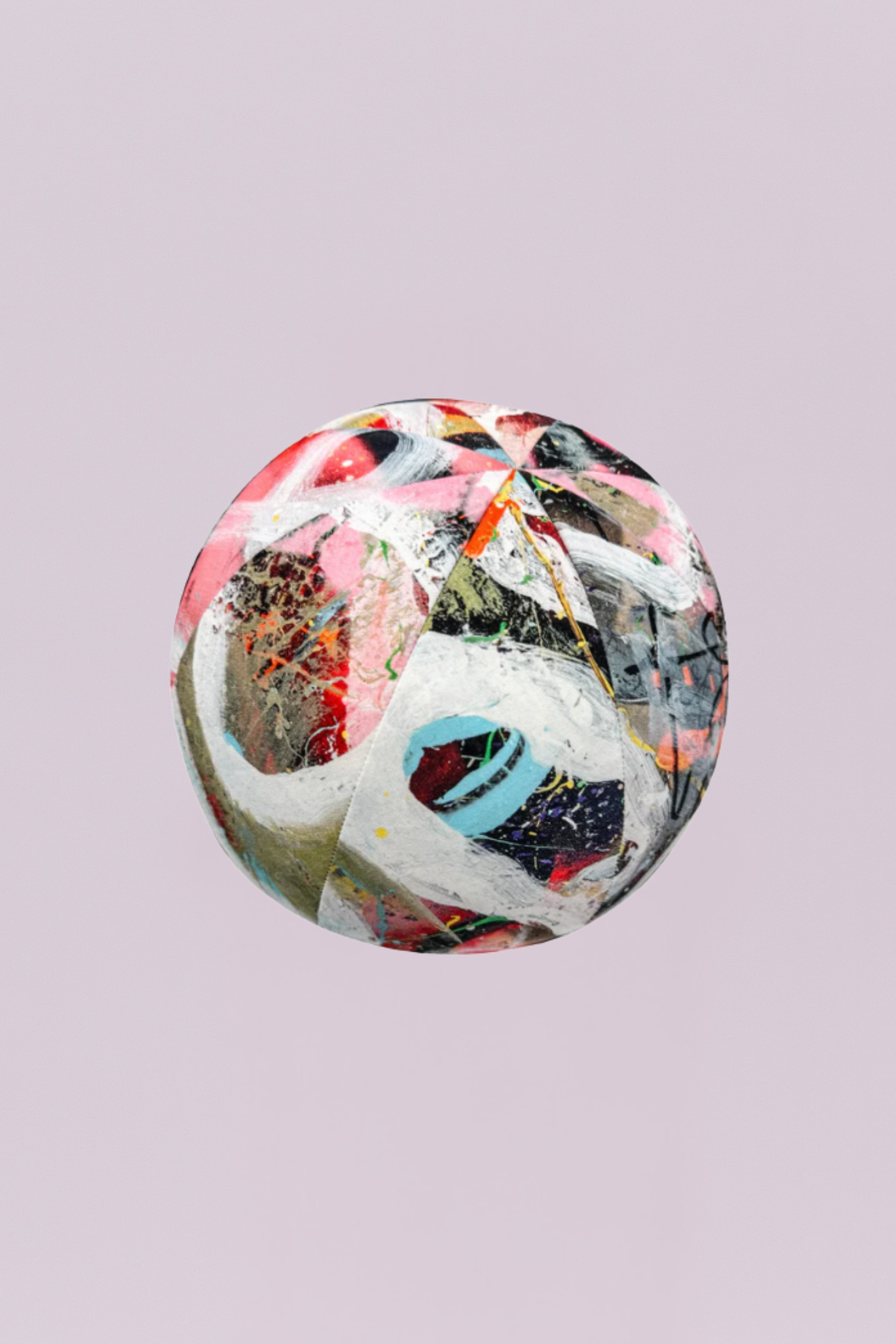 A truly unique, spherical accent pillow featuring a dynamic, multi-color abstract print that resembles street art or expressionist painting. With bold splatters of pink, white, black, blue, and orange, this artistic piece adds a playful, modern dimension and unexpected shape to any space.