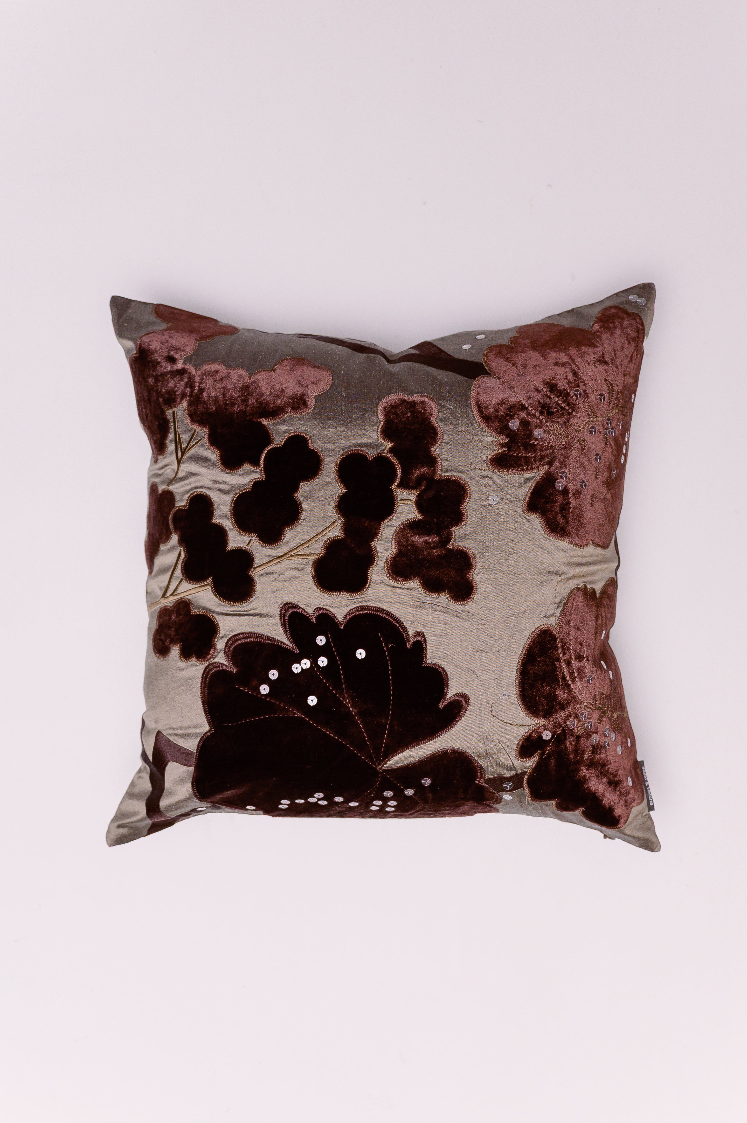 Indulge in the rich texture and autumnal glamour of The Vintage Bloom Accent. This exquisite pillow features a luxurious two-tone design that beautifully blends high-end textures and moody colors. The velvet florals are enhanced by subtle, hand-stitched silver sequin details that catch the light, adding a hint of sparkle without losing its classic elegance. This pillow is a decadent statement piece, perfect for bringing sophisticated depth and tactile luxury to any transitional or glamorous interior.
