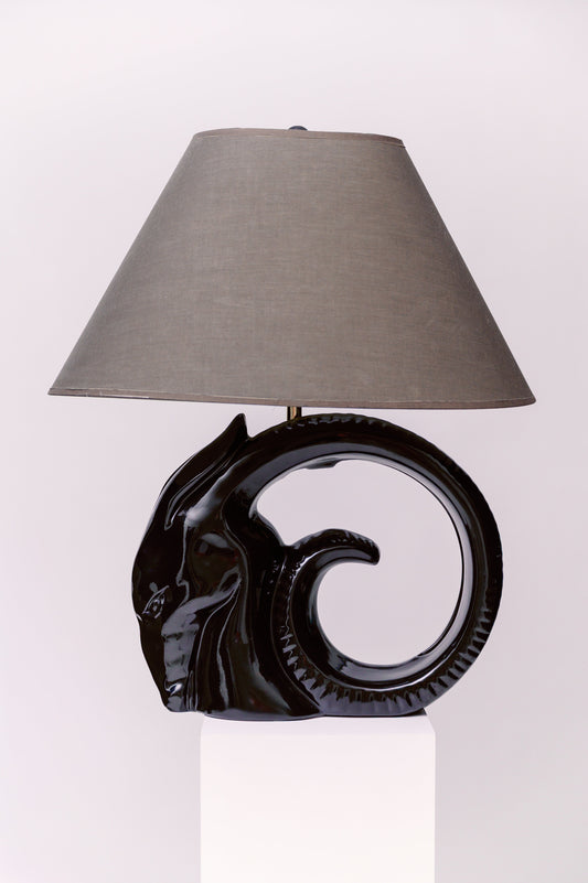 A Pair of vintage Italian matching glazed porcelain table lamps designed with a horned ram head head shape. In black color with a high gloss finish.