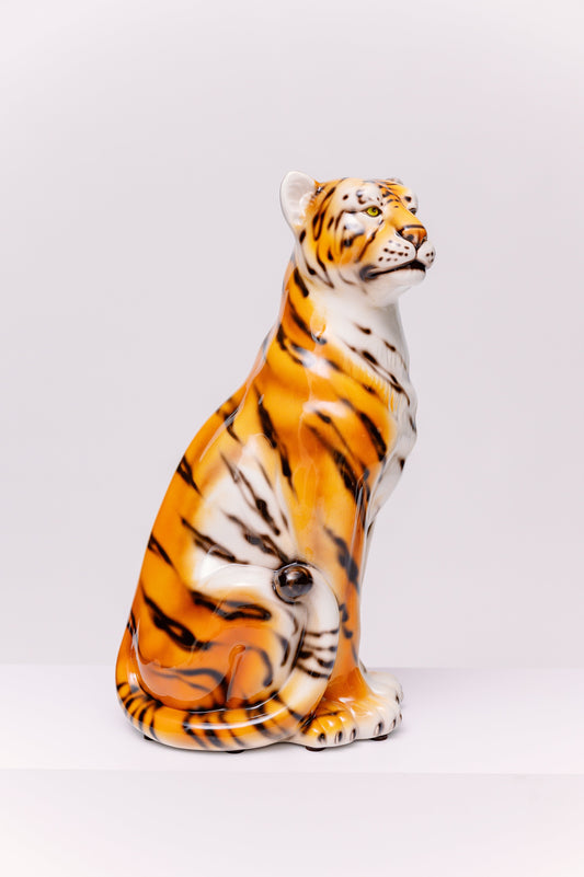 This striking, vintage ceramic tiger captures the glamour of the Mid-Century Modern and Hollywood Regency styles. Hand-painted with rich orange, white, and black stripes and finished with a brilliant high-gloss glaze, this piece is a bold statement.