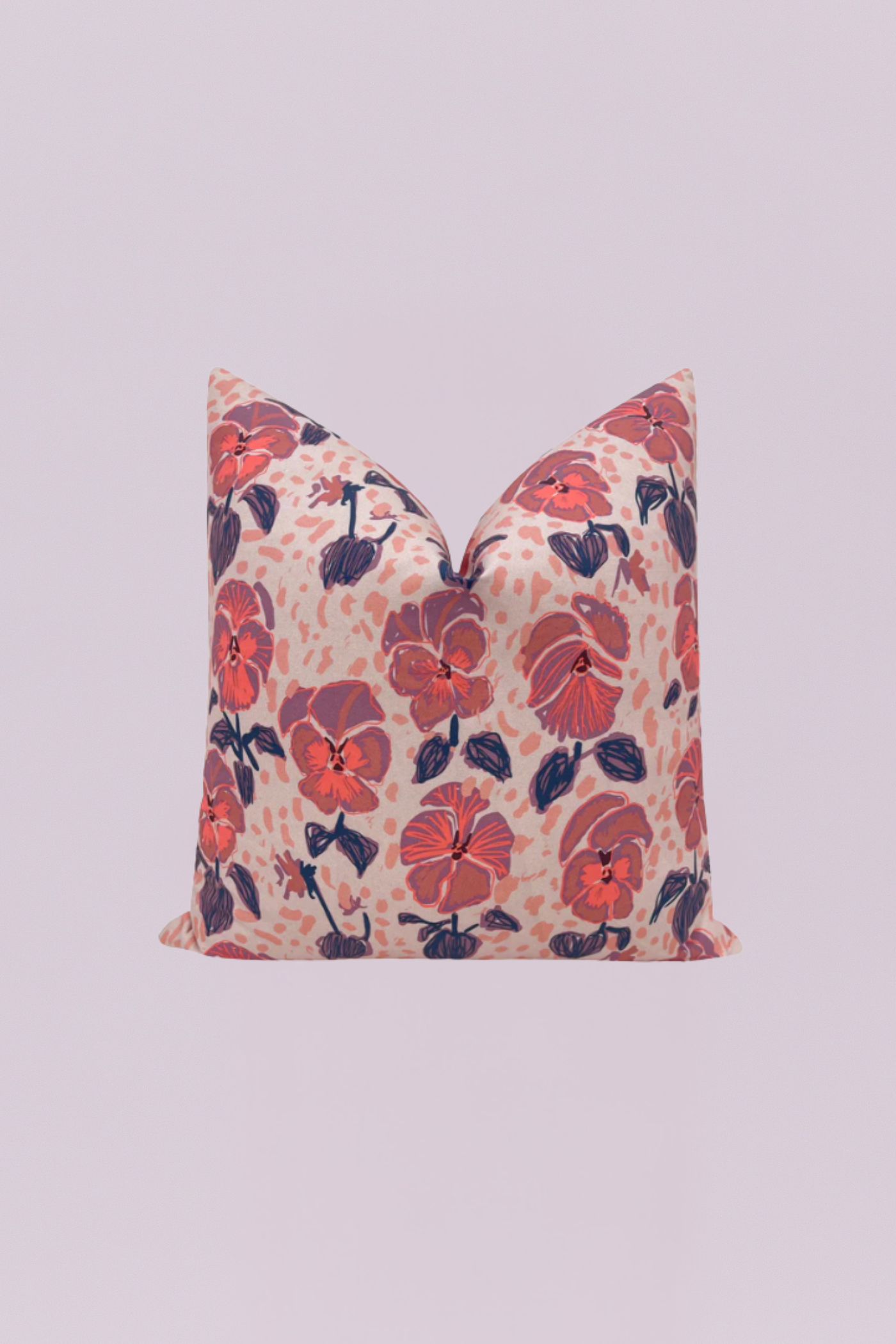 A painterly and romantic accent pillow showcasing large, stylized pansy florals in vibrant coral, mauve, and purple tones against a blush-pink, subtly speckled background. This artistic floral print brings a lush, feminine touch to your decor.